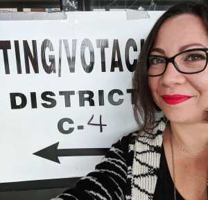 Red lips, blue ballot. Woman at a polling station.